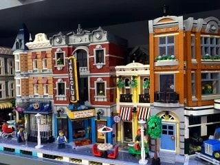 Detailed Lego street scene featuring modular buildings, including a jazz club, café, and various storefronts.